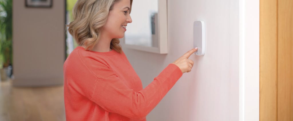 woman at house alarm keypad